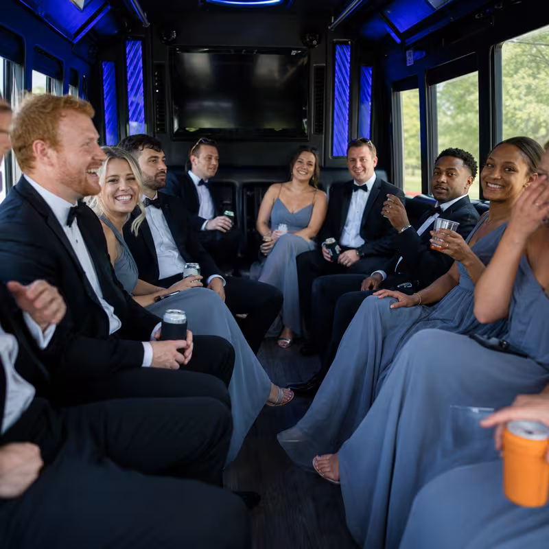 Wedding guests seated inside a Indianapolis party bus