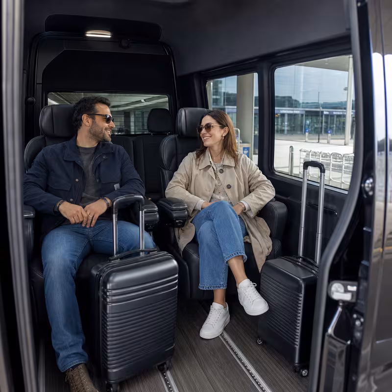 Passengers loading luggage while boarding an Indianapolis group shuttle