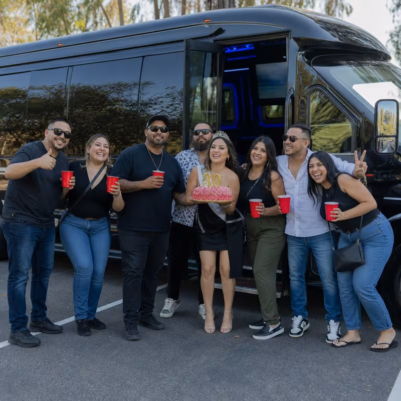 Group boarding a white charter bus for Birthday Transportation transportation in Indianapolis