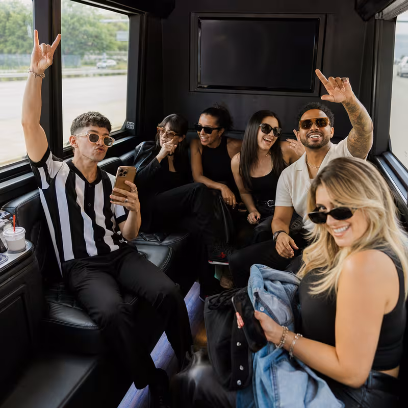 Group boarding a white charter bus for Concert Transportation transportation in Indianapolis