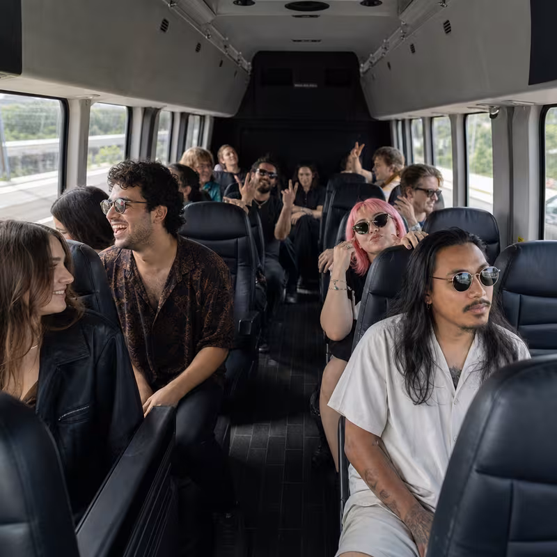 Party bus interior with wraparound leather seating and LED lighting in Indianapolis