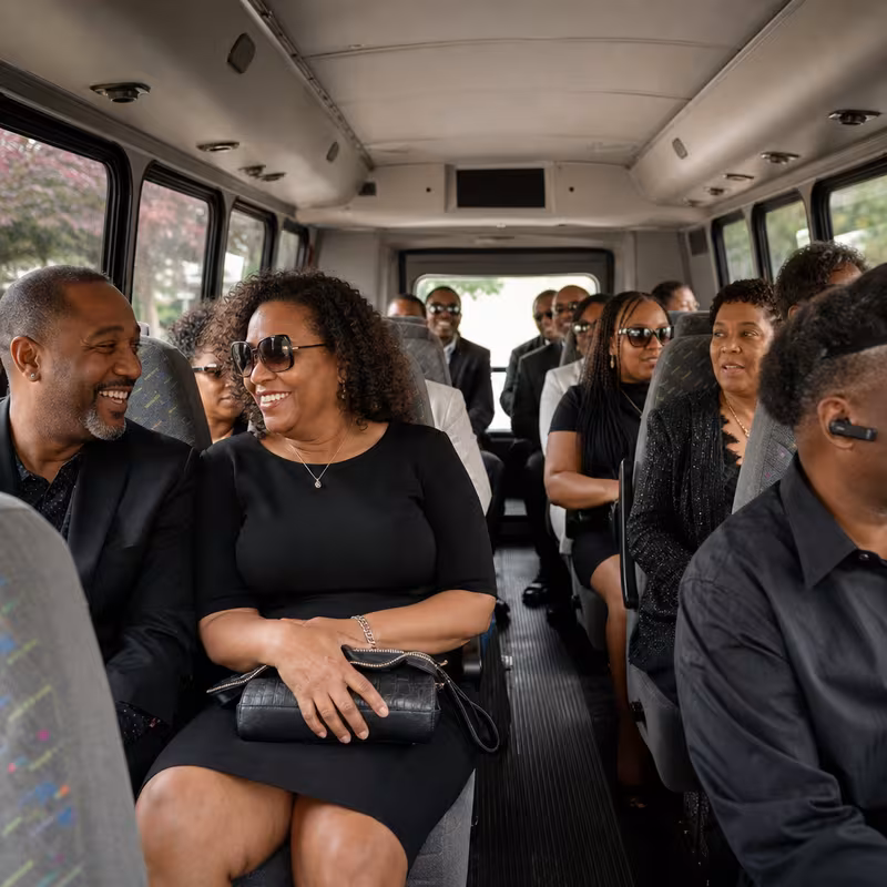 Group boarding a white charter bus for Private Event Transportation transportation in Indianapolis