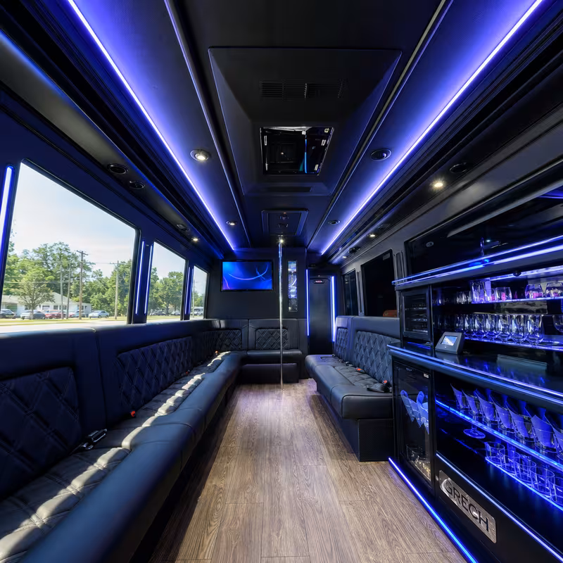 Party bus interior with wraparound leather seating and LED lighting in Indianapolis