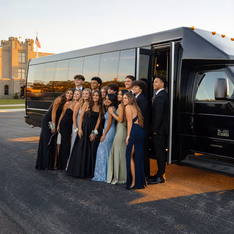Group boarding a white charter bus for Prom & Homecoming Transportation transportation in Indianapolis