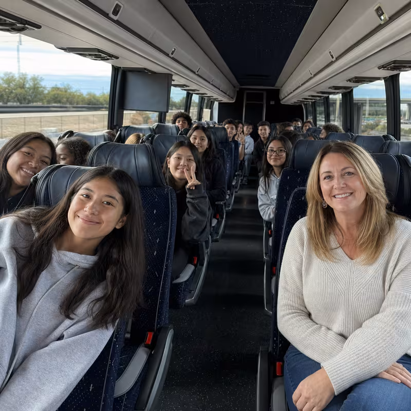 Group boarding a white charter bus for School Transportation transportation in Indianapolis