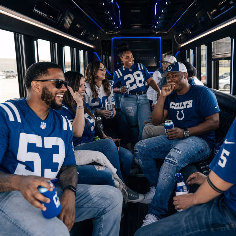 Group boarding a white charter bus for Sporting Event Transportation transportation in Indianapolis