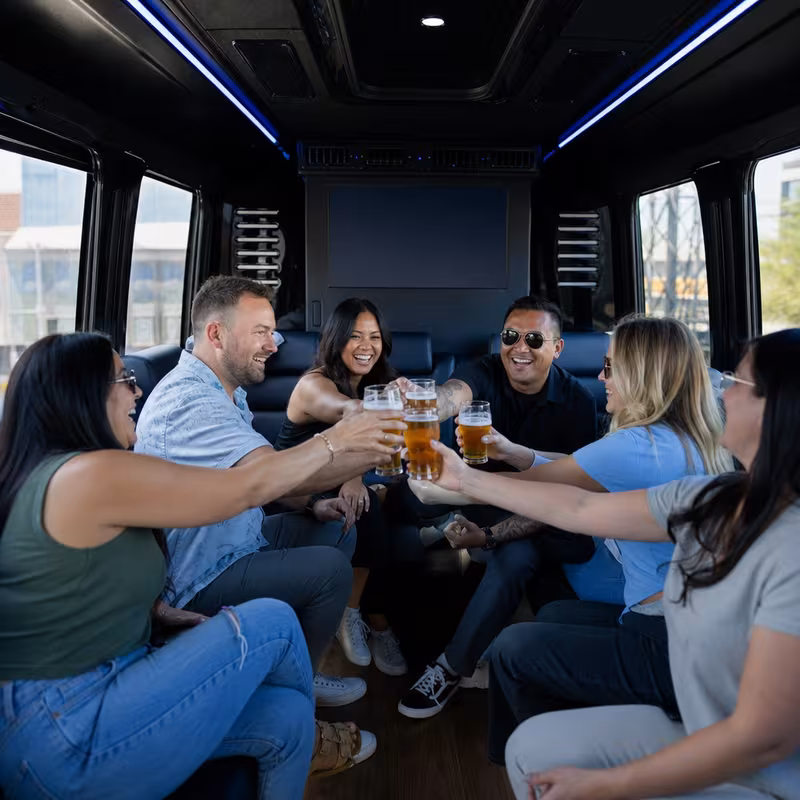 Group boarding a white charter bus for Winery & Brewery Tour Transportation transportation in Indianapolis