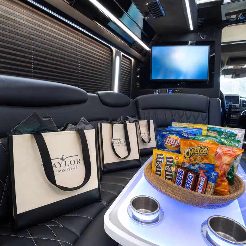 Party bus interior with wraparound leather seating and LED lighting in Indianapolis